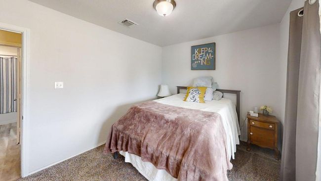 Carpeted bedroom featuring baseboards | Image 13