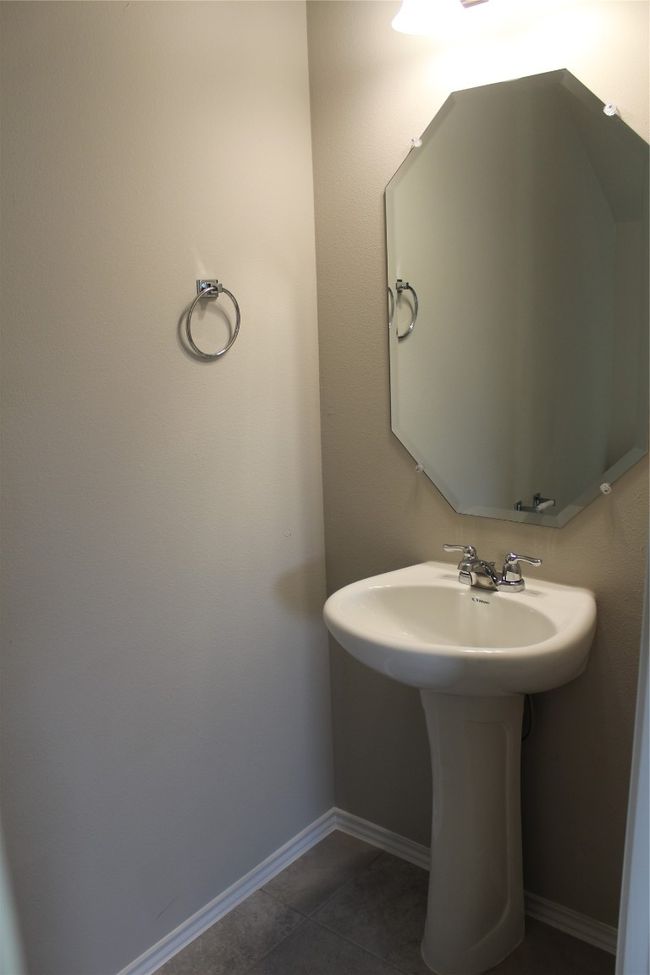 Bathroom featuring tile patterned flooring, baseboards, and a sink | Image 10