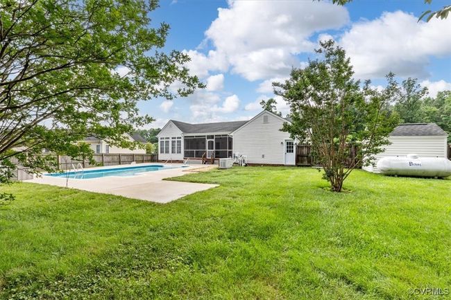 Back of house with a sunroom and a patio | Image 50