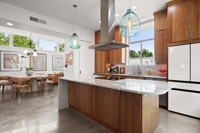 Waterdrop light fixtures highlight the water like flow of the counters and outdoor light | Image 10