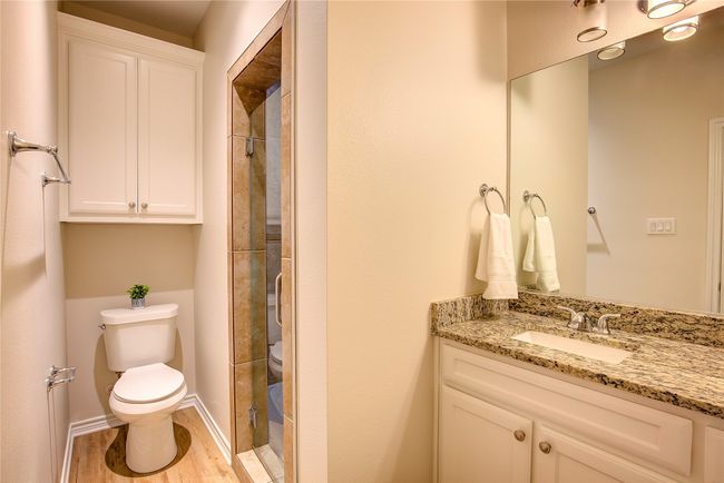 Full bath featuring vanity, a shower stall, and wood finished floors | Image 22