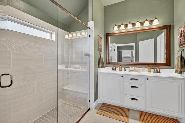 Bathroom featuring a shower stall, double vanity, and tile patterned flooring | Image 27