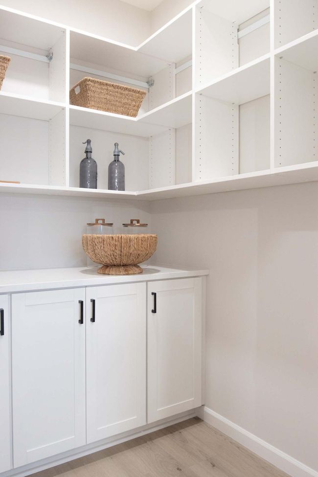 The walk-in pantry of your dreams offers ample storage space, with custom shelving and organization solutions to keep everything neat and easily accessible. Photos are from previously built home; options and features will vary. | Image 12