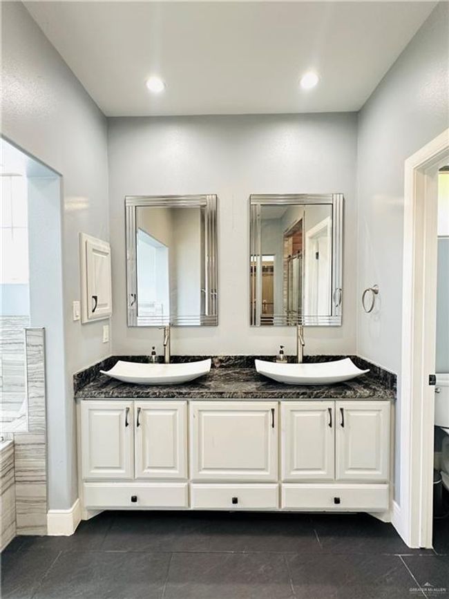 Bathroom with double vanity, tile patterned flooring, and recessed lighting | Image 10