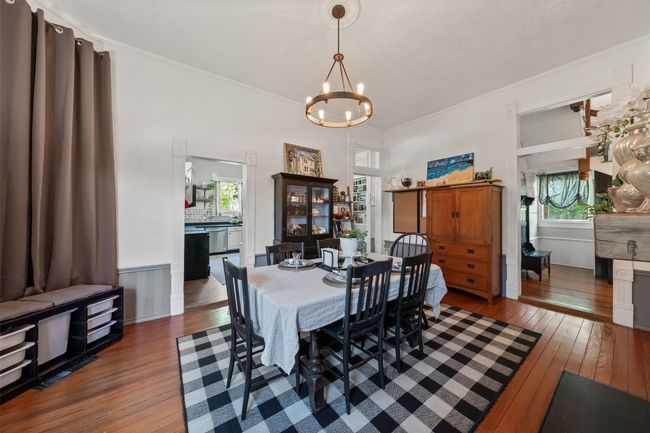 Dining area with hardwood / wood-style floors, healthy amount of natural light, a chandelier, and ornamental molding | Image 12