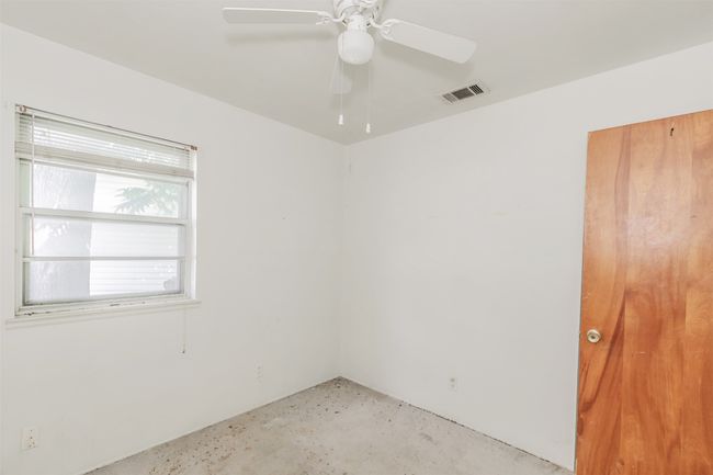 Empty room featuring ceiling fan and concrete flooring | Image 26