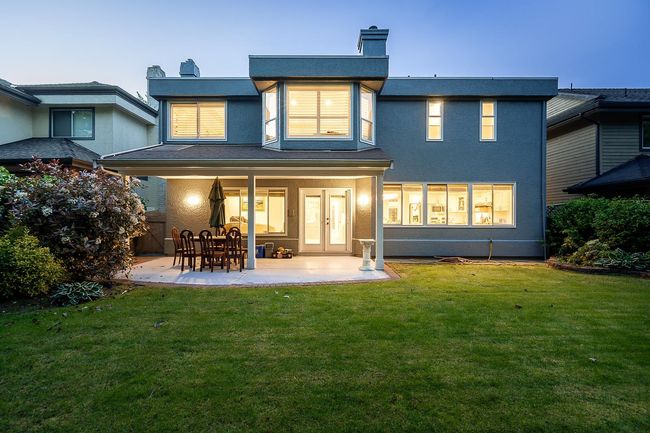 Rear view of house featuring stucco siding, a yard, and a patio area | Image 27