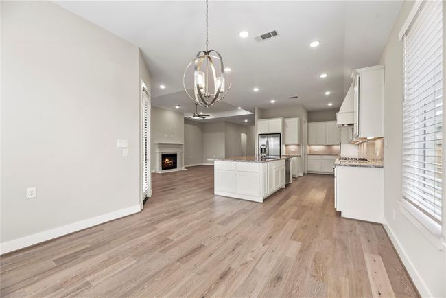 Gather them around your table to honor old traditions and create the new. This elegant dining room with a sleek chandeler is the perfect space to do just that. | Image 13