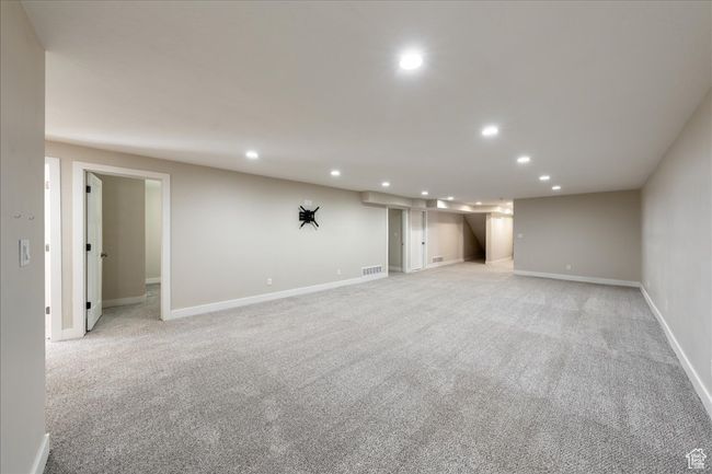 Finished basement featuring recessed lighting, baseboards, visible vents, and light colored carpet | Image 41