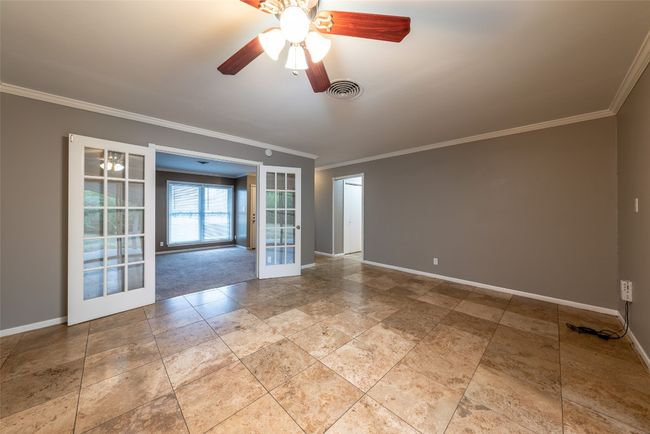 Empty room with french doors, ornamental molding, and a ceiling fan | Image 13