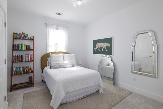 Bedroom featuring baseboards, visible vents, and light colored carpet | Image 17