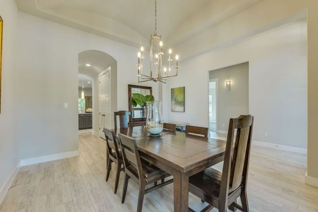 Formal dining area with curved ceilings & chandelier | Image 9