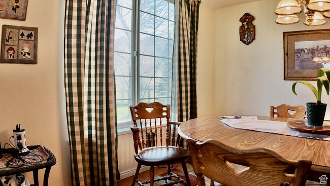 Dining room featuring a chandelier, wood finished floors, and a wealth of natural light | Image 74