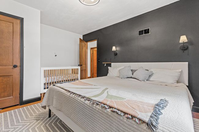 Large bedroom one with natural hardwood floors | Image 20