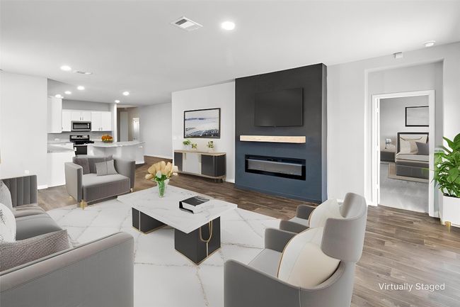 Living room with recessed lighting, a fireplace, and wood finished floors | Image 7