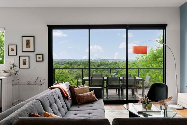 This living space is filled with natural light. Custom motorized shades throughout! | Image 9