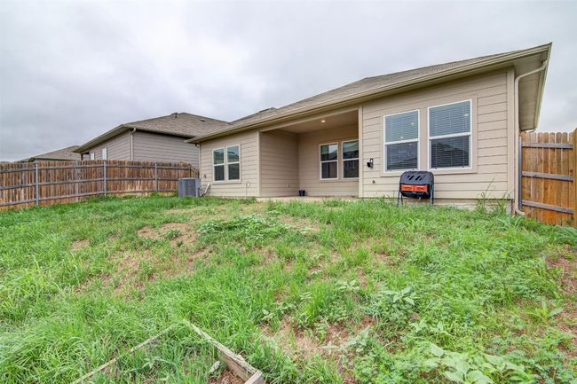 Rear view of house with central air condition unit and fence | Image 28
