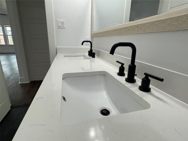 Bathroom view of a sink and wood finished floors | Image 31