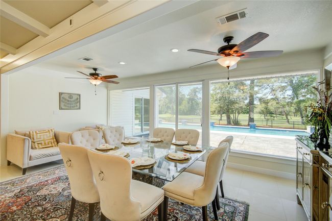 The open-concept dining area has a wonderful view of the pool and golf course with room for additional seating. | Image 11