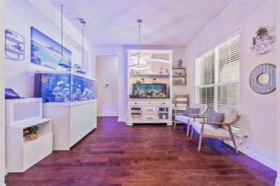 Formal Dining room area used as a living area with hardwood flooring. | Image 3