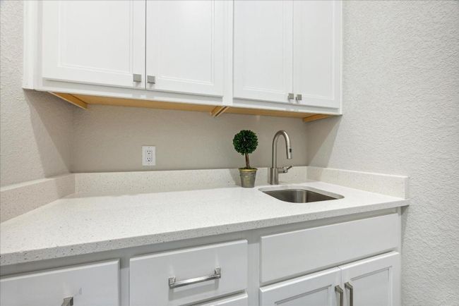 A full sink and lots of cabinet space make the utility room incredibly functional. | Image 36