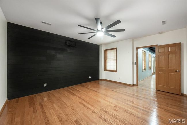 Unfurnished room with a ceiling fan, light wood-style flooring, and baseboards | Image 38