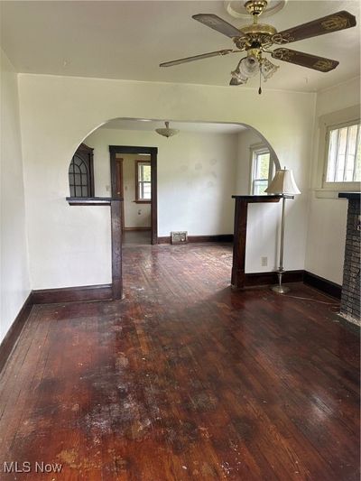 Spare room featuring wood-type flooring, ceiling fan, and plenty of natural light | Image 3