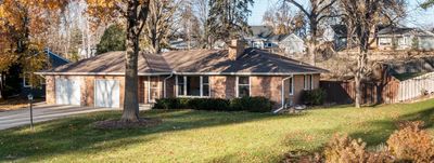 Mid-century modern gem. All brick exterior home with concrete driveway in ideal location. | Image 1