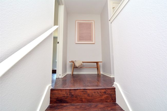 Stairs featuring wood finished floors | Image 10