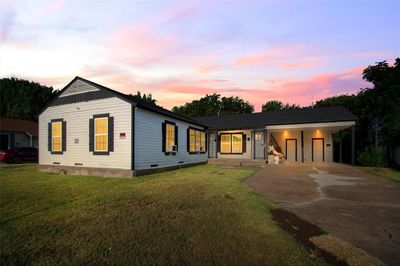 View of front of home featuring a carport and a lawn | Image 1