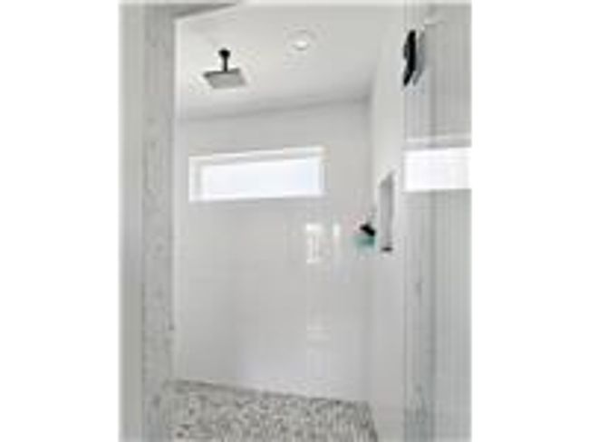 Full bathroom featuring a tile shower and a good amount of natural sunlight | Image 25
