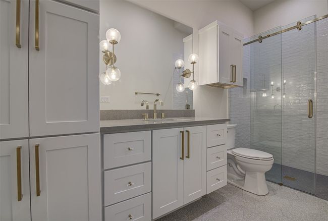Bathroom with vanity, a shower stall, and toilet | Image 17