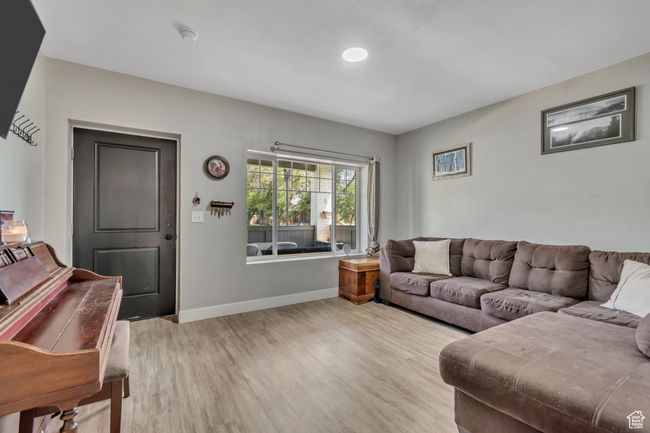 Living room featuring light wood finished floors and baseboards | Image 4