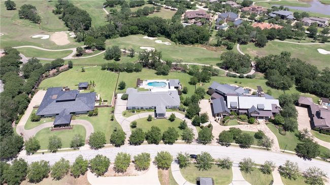 Aerial view of property and surrounding area with a golf course, nearby suburban area, and a nearby body of water | Image 28