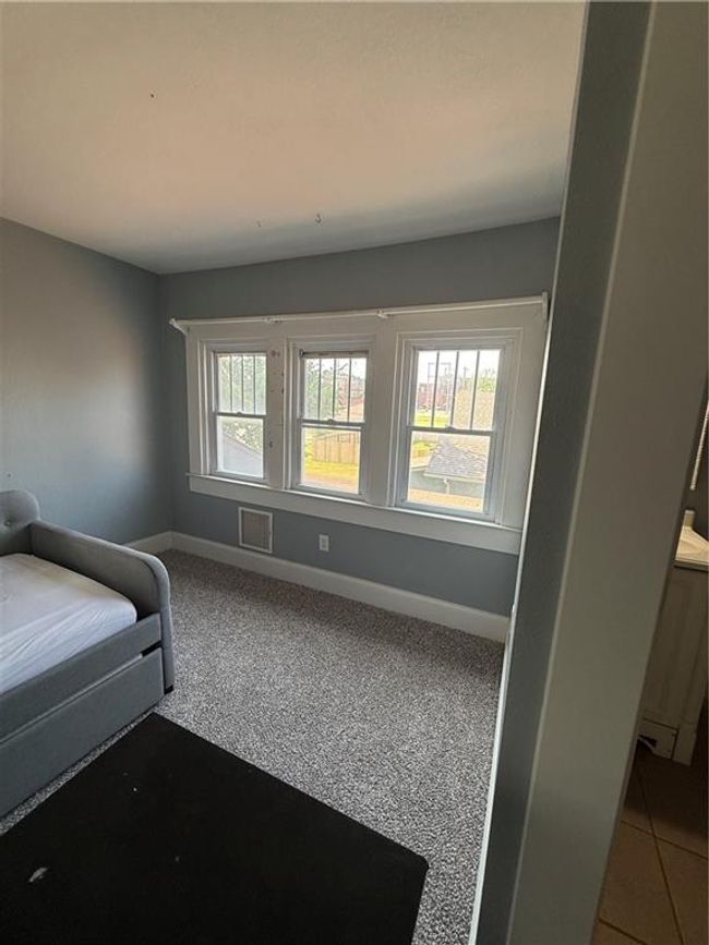 Carpeted bedroom featuring baseboards | Image 16