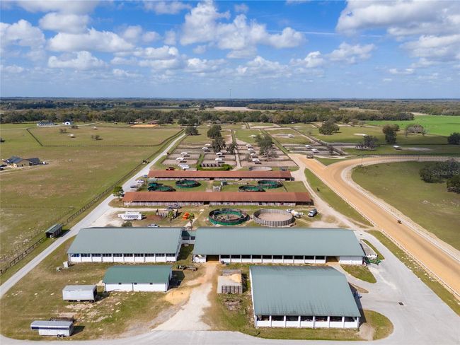 Newer barn with equipment building in foreground and hydrotherapy facility to the left of the newer barn | Image 7
