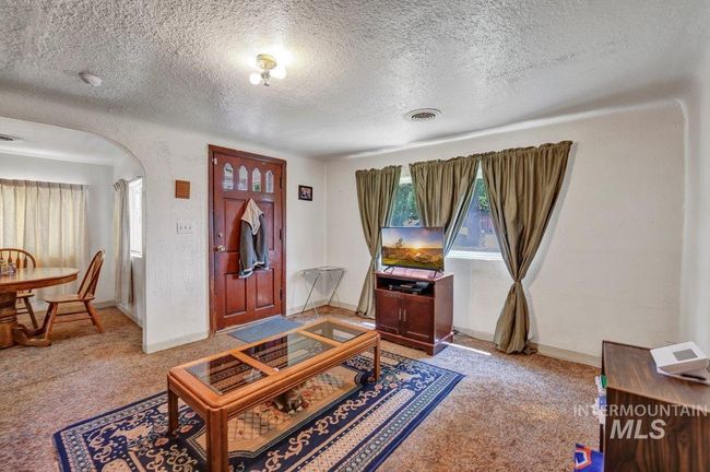 Foyer with arched walkways, light colored carpet, and a textured ceiling | Image 14