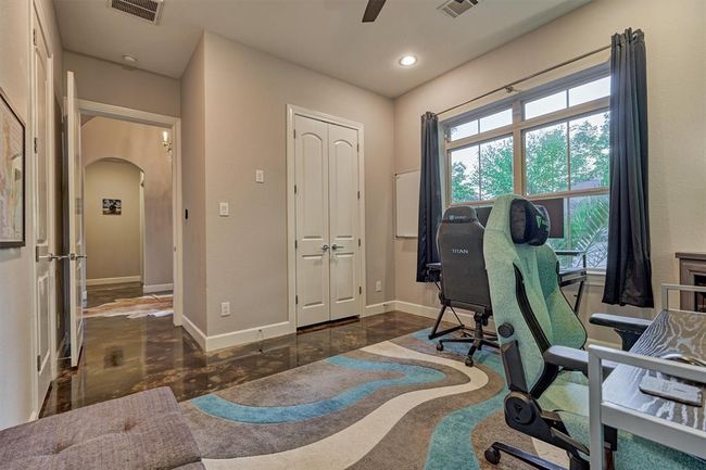 This versatile bedroom offers a spacious walk-in closet and direct access to a full bath, making it ideal for guests or a comfortable home office setup. | Image 10