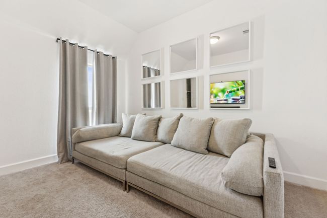 Carpeted living area featuring baseboards | Image 14