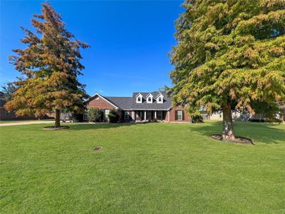 View of front facade with a front yard | Image 1