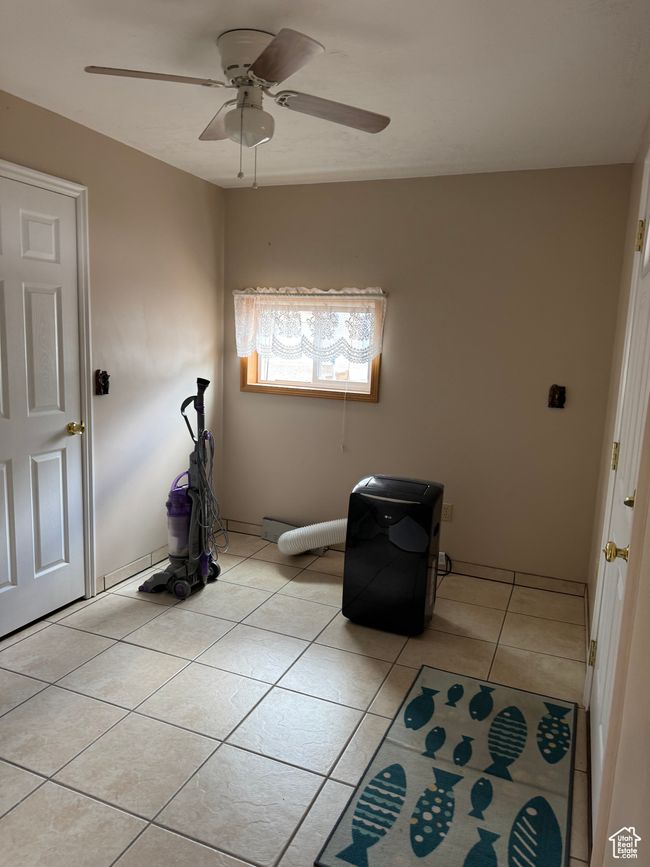 Spare room featuring ceiling fan and light tile patterned floors | Image 15