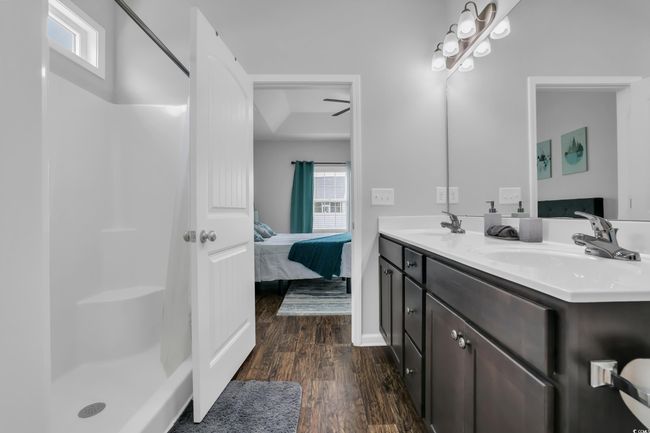 Bathroom featuring a healthy amount of sunlight, a sink, and ensuite bathroom | Image 33