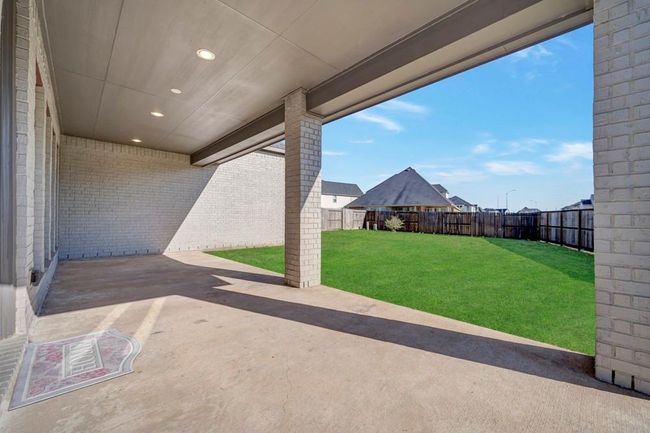 Covered patio with gas outlet for your grill. Create a cozy spot to watch children play. | Image 32