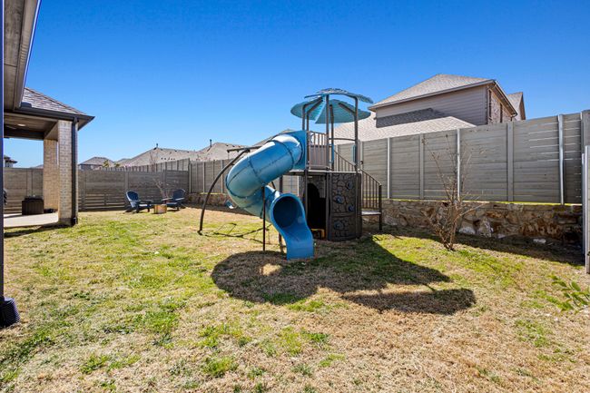View of yard with a playground and a fenced backyard | Image 30
