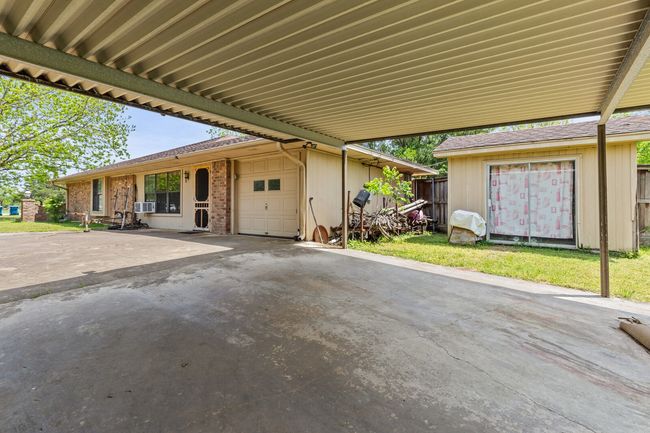 View of patio / terrace with fence, a carport, and a garage | Image 37