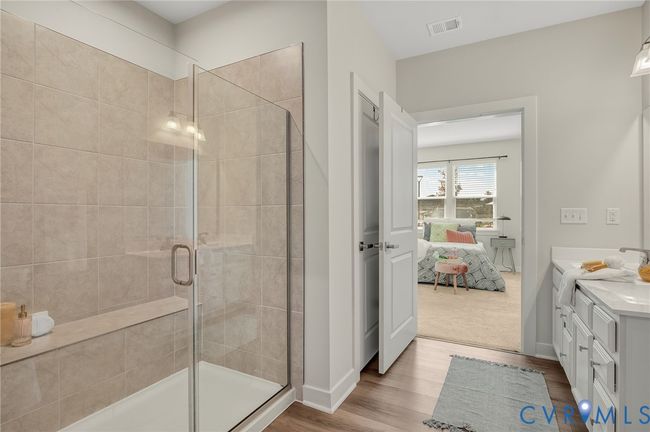 Bathroom featuring connected bathroom, wood finished floors, vanity, and a stall shower | Image 17