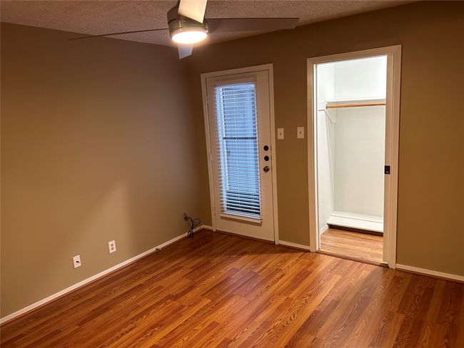 Spare room featuring ceiling fan, a textured ceiling, and hardwood / wood-style flooring | Image 14