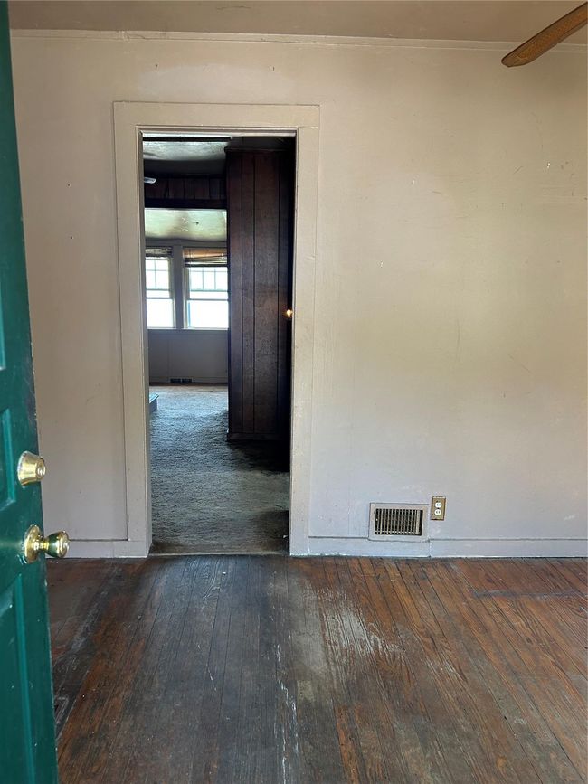 Empty room featuring wood-type flooring, visible vents, and baseboards | Image 15