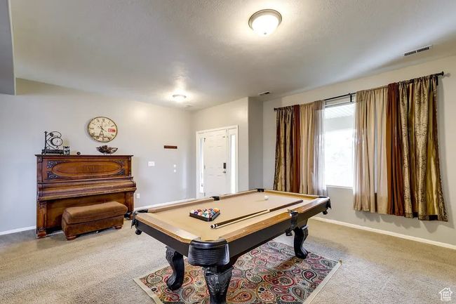 Recreation room with billiards, carpet, baseboards, and visible vents | Image 11