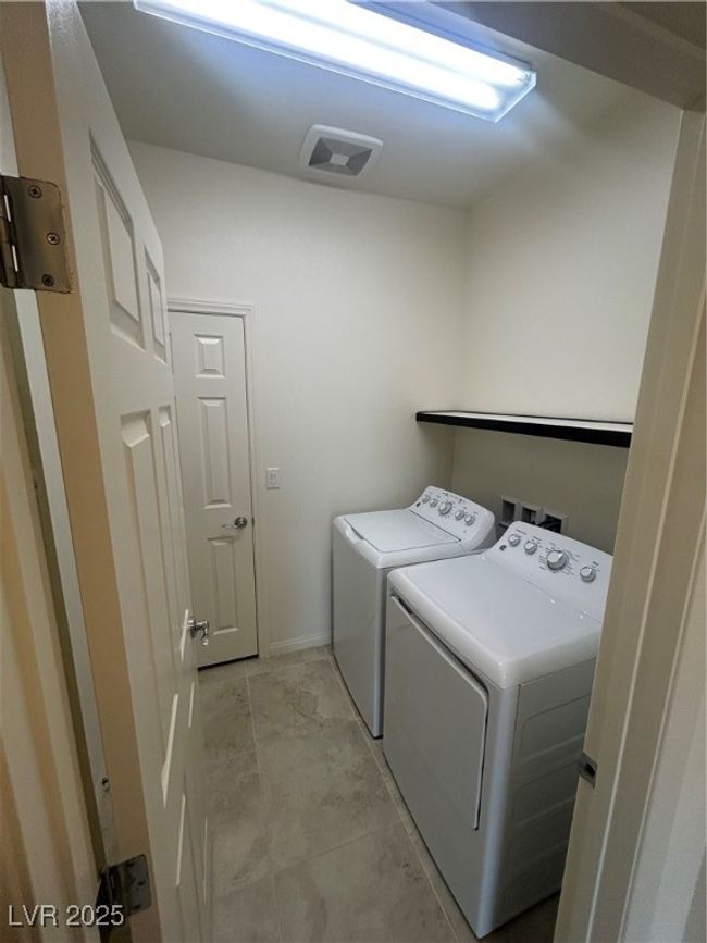 Washroom with separate washer and dryer and baseboards | Image 8